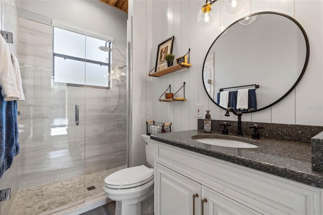 bathroom with an enclosed shower, vanity, and toilet