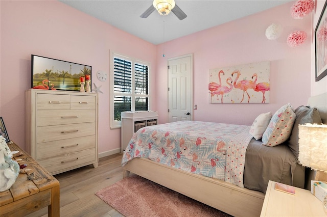 bedroom with ceiling fan and light wood-type flooring