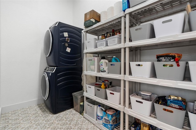 storage featuring stacked washer and clothes dryer