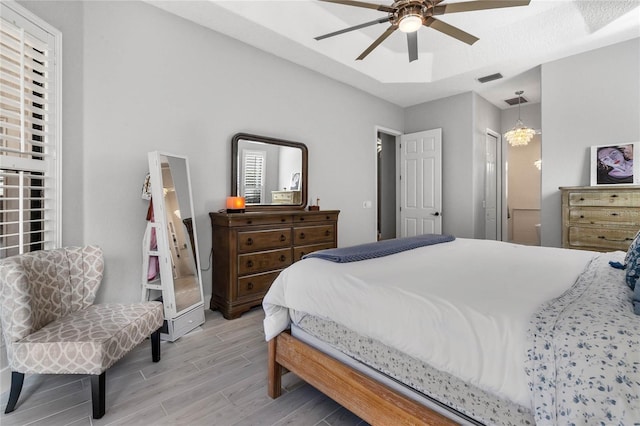 bedroom with light hardwood / wood-style floors and ceiling fan