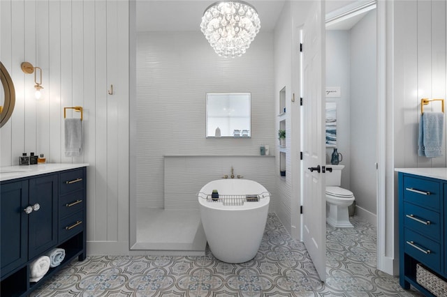 bathroom featuring a tub, an inviting chandelier, tile patterned flooring, toilet, and vanity