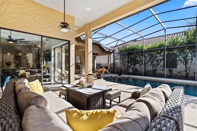 view of patio / terrace featuring a lanai, ceiling fan, and an outdoor living space