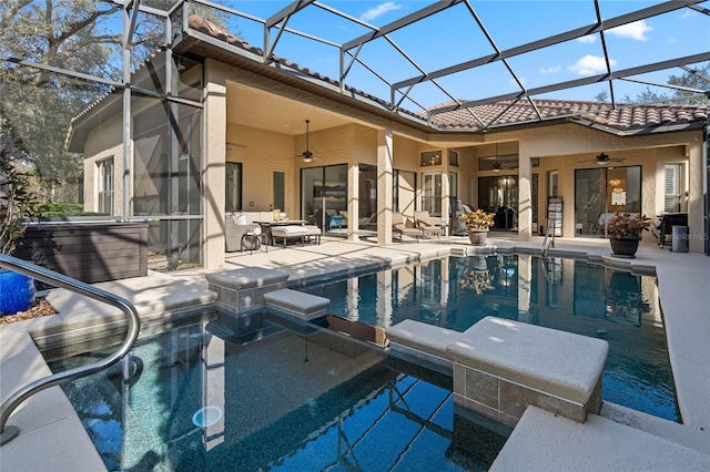 view of pool with a patio, glass enclosure, a hot tub, and ceiling fan