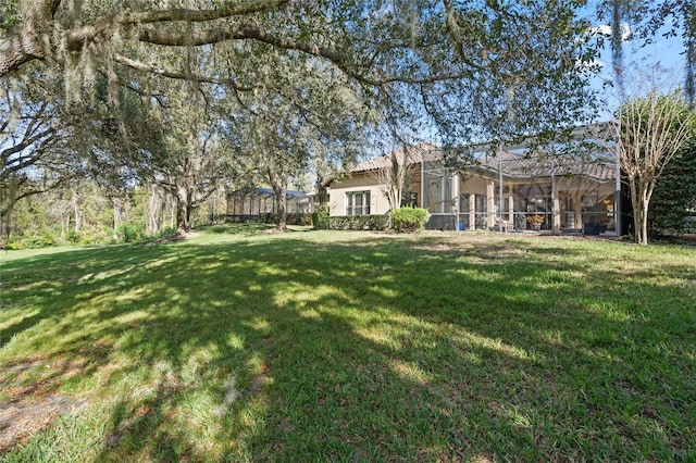 view of yard featuring glass enclosure