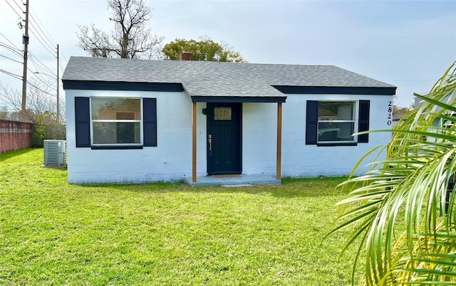 view of front of property with a front lawn and central air condition unit