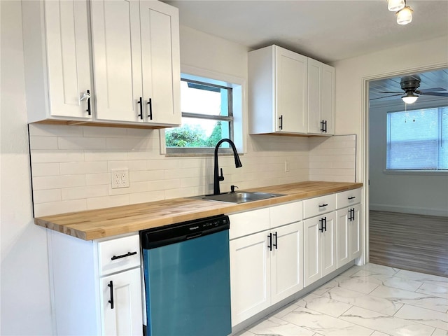 kitchen featuring butcher block countertops, stainless steel dishwasher, and white cabinetry