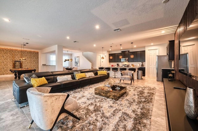 living room featuring a textured ceiling and pool table