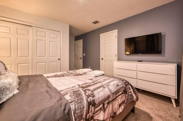 bedroom with carpet flooring, a closet, and a textured ceiling