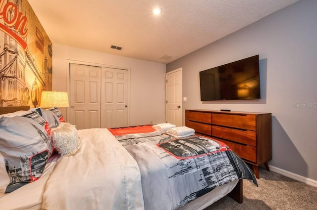 carpeted bedroom featuring a closet and a textured ceiling