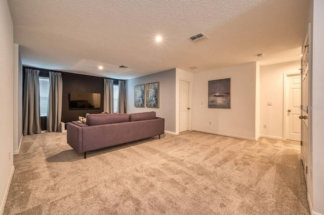 living room with light carpet and a textured ceiling