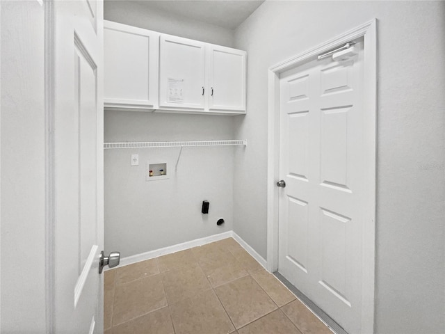 washroom featuring washer hookup, hookup for an electric dryer, cabinets, and light tile patterned floors