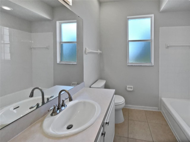 bathroom featuring tile patterned flooring, vanity, toilet, and a wealth of natural light