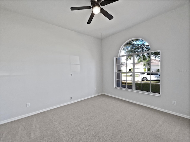 carpeted spare room with ceiling fan