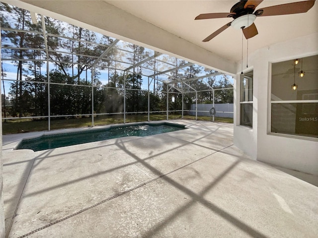 view of pool with a patio, ceiling fan, and a lanai