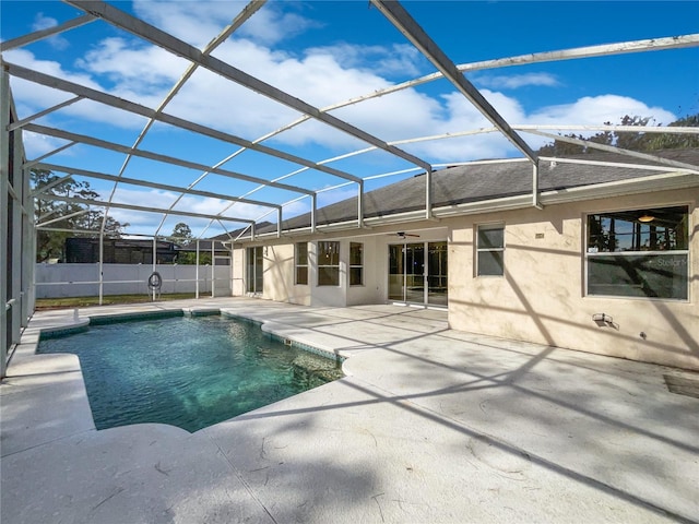 view of swimming pool featuring a patio and glass enclosure