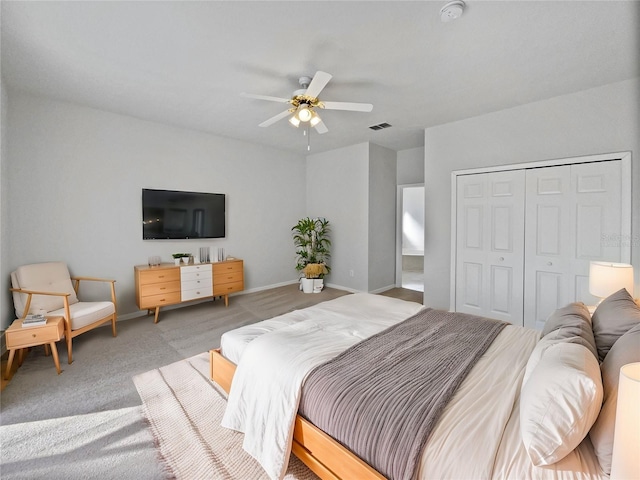 carpeted bedroom with a closet and ceiling fan