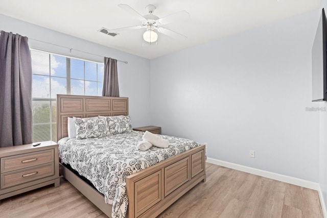 bedroom with light hardwood / wood-style floors and ceiling fan