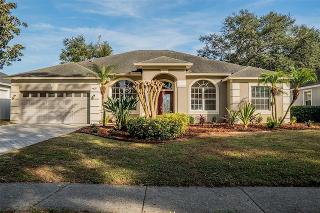 view of front facade featuring a front yard and a garage