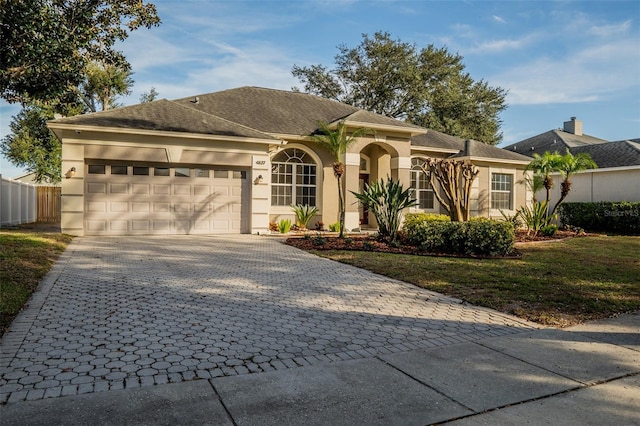 view of front of property with a front lawn and a garage