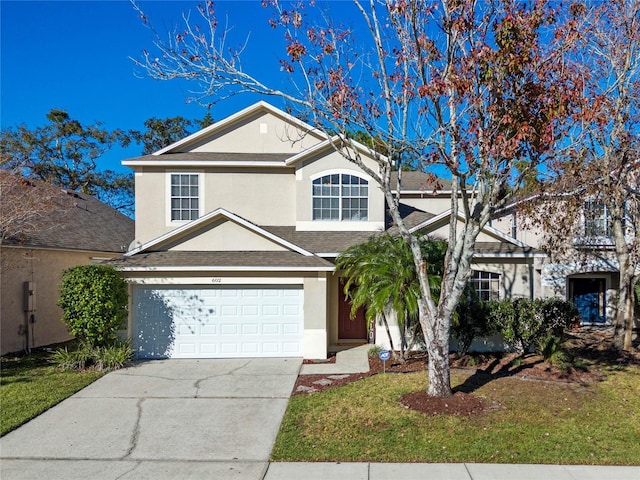 view of front property with a garage and a front lawn