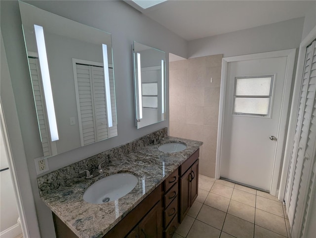 bathroom with tile patterned flooring and vanity