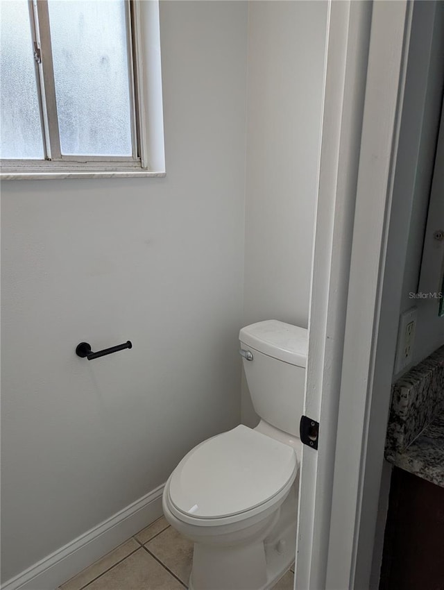 bathroom with tile patterned floors and toilet