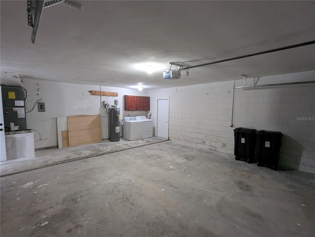 garage with a garage door opener, water heater, and washing machine and clothes dryer