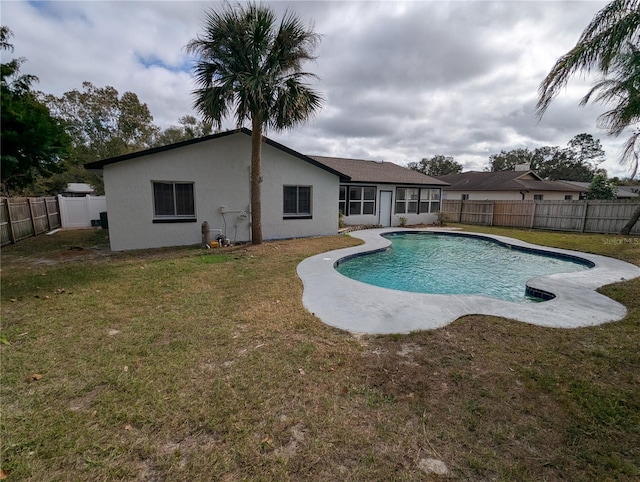 view of pool with a yard