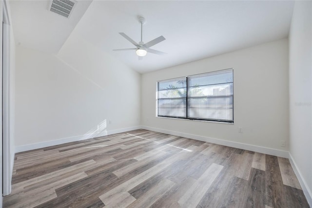 unfurnished room featuring ceiling fan, vaulted ceiling, and light hardwood / wood-style flooring