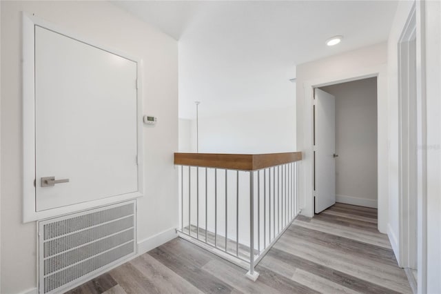 hallway with light hardwood / wood-style floors