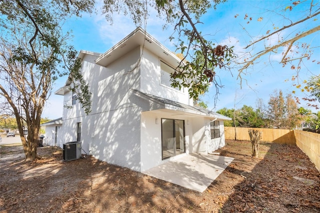 back of property featuring central AC unit and a patio