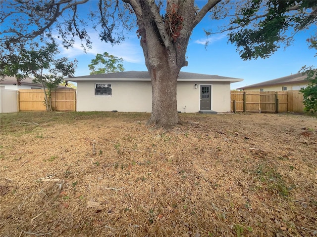 rear view of property with a yard