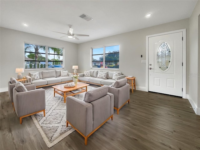 living room featuring dark hardwood / wood-style flooring and ceiling fan