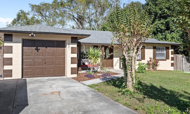 view of front of home with a garage and a front lawn