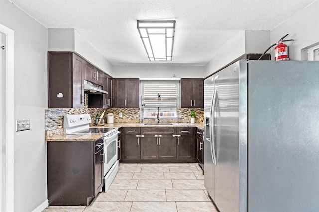 kitchen with stainless steel fridge, a textured ceiling, white electric stove, and backsplash