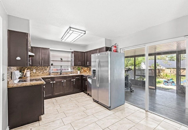 kitchen with backsplash, stainless steel appliances, plenty of natural light, and sink