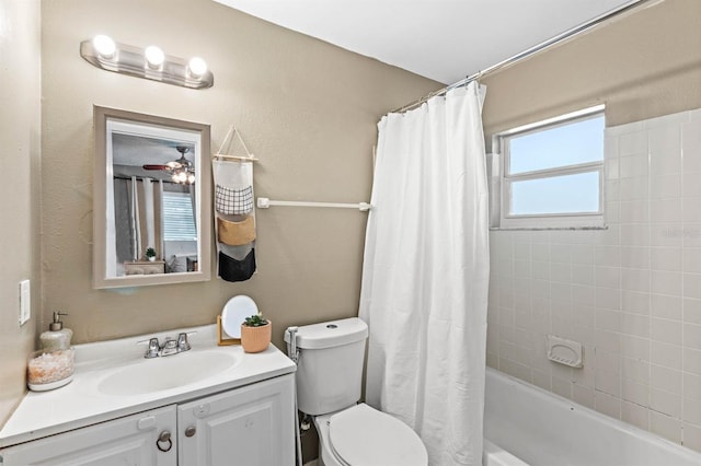 full bathroom featuring ceiling fan, toilet, vanity, and shower / tub combo with curtain