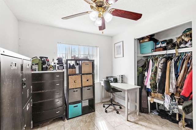 office featuring ceiling fan and a textured ceiling