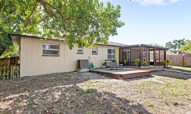 back of property featuring central air condition unit and a sunroom