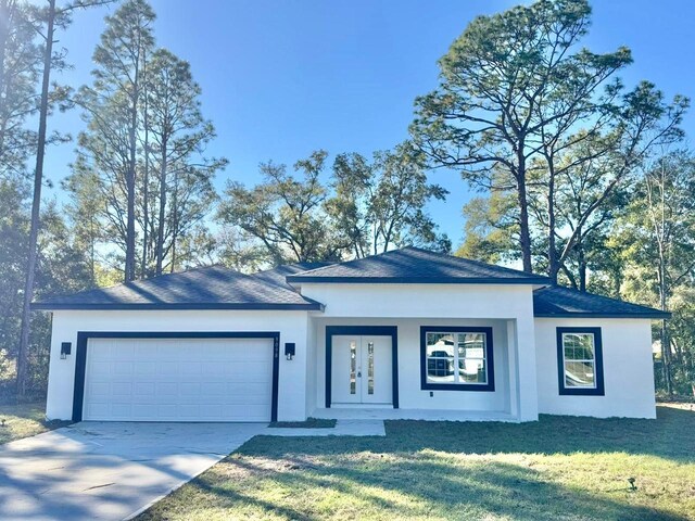 view of front of home with a front lawn, covered porch, and a garage