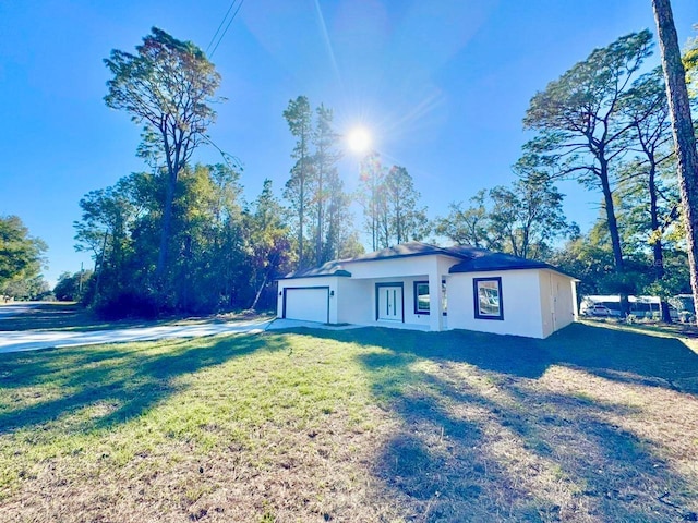 view of front of home with a garage and a front yard