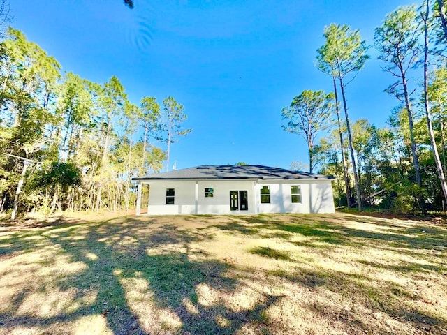 rear view of house with a lawn