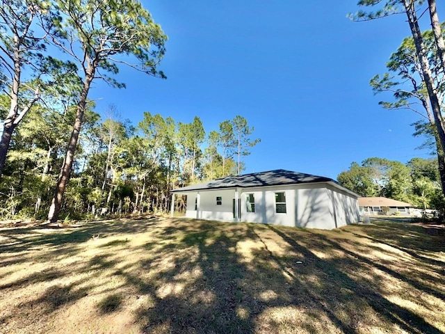 rear view of house with a lawn