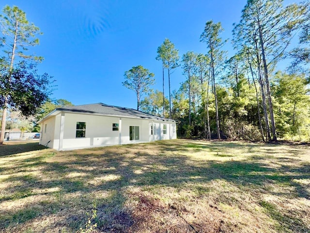 back of property featuring a lawn