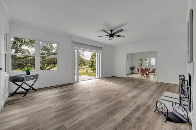 sitting room with ornamental molding, light hardwood / wood-style floors, and ceiling fan