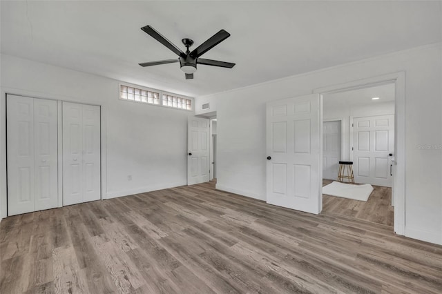 unfurnished bedroom featuring ceiling fan and light hardwood / wood-style flooring