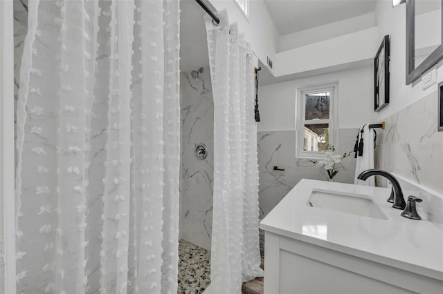 bathroom featuring tile walls, vanity, and a shower with curtain