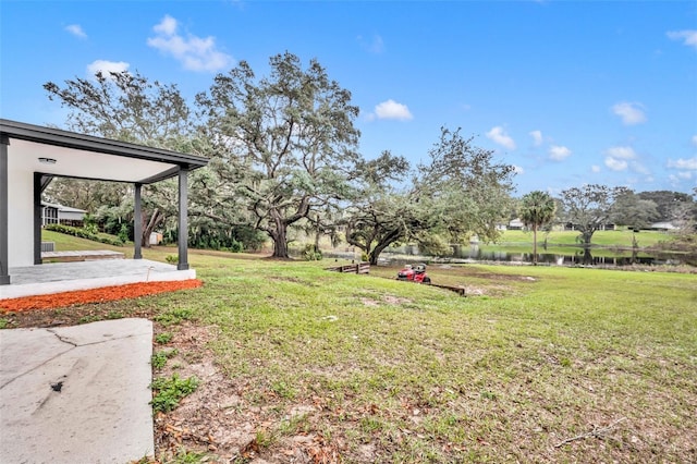 view of yard featuring a patio area and a water view