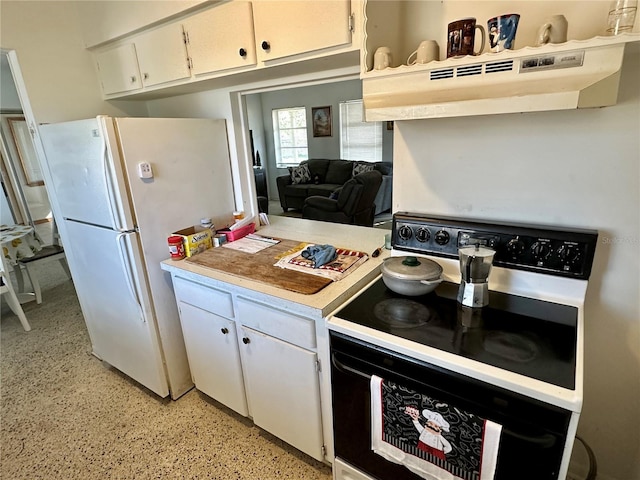 kitchen with electric range, white refrigerator, white cabinets, and exhaust hood