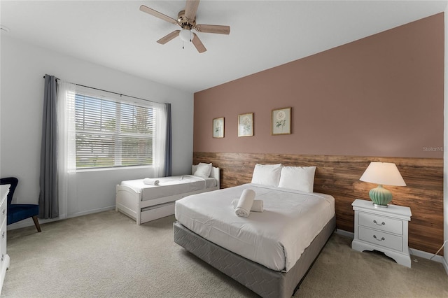 bedroom featuring light carpet and ceiling fan